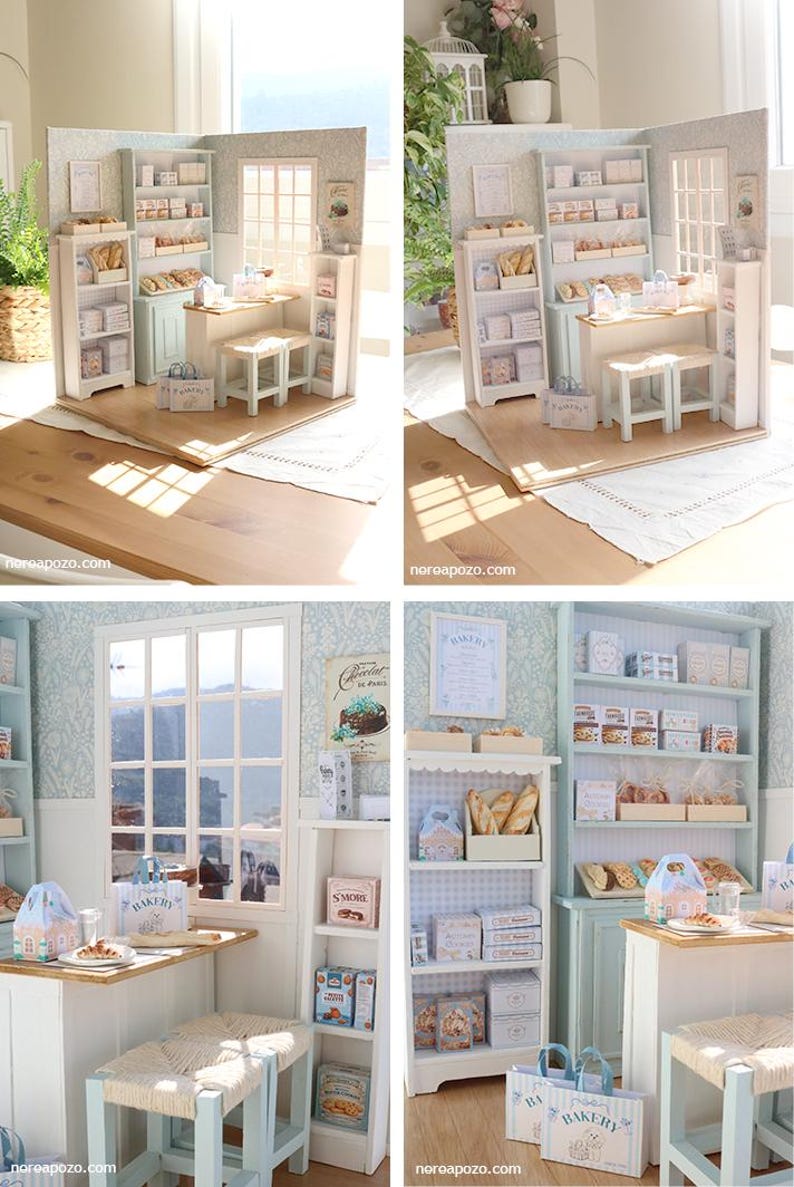 May include: A miniature bakery diorama featuring light blue and white shelving units, a wooden counter, two stools with woven seats, and various small boxes and bags labeled with bakery-themed text. The scene includes a window and wall decor.