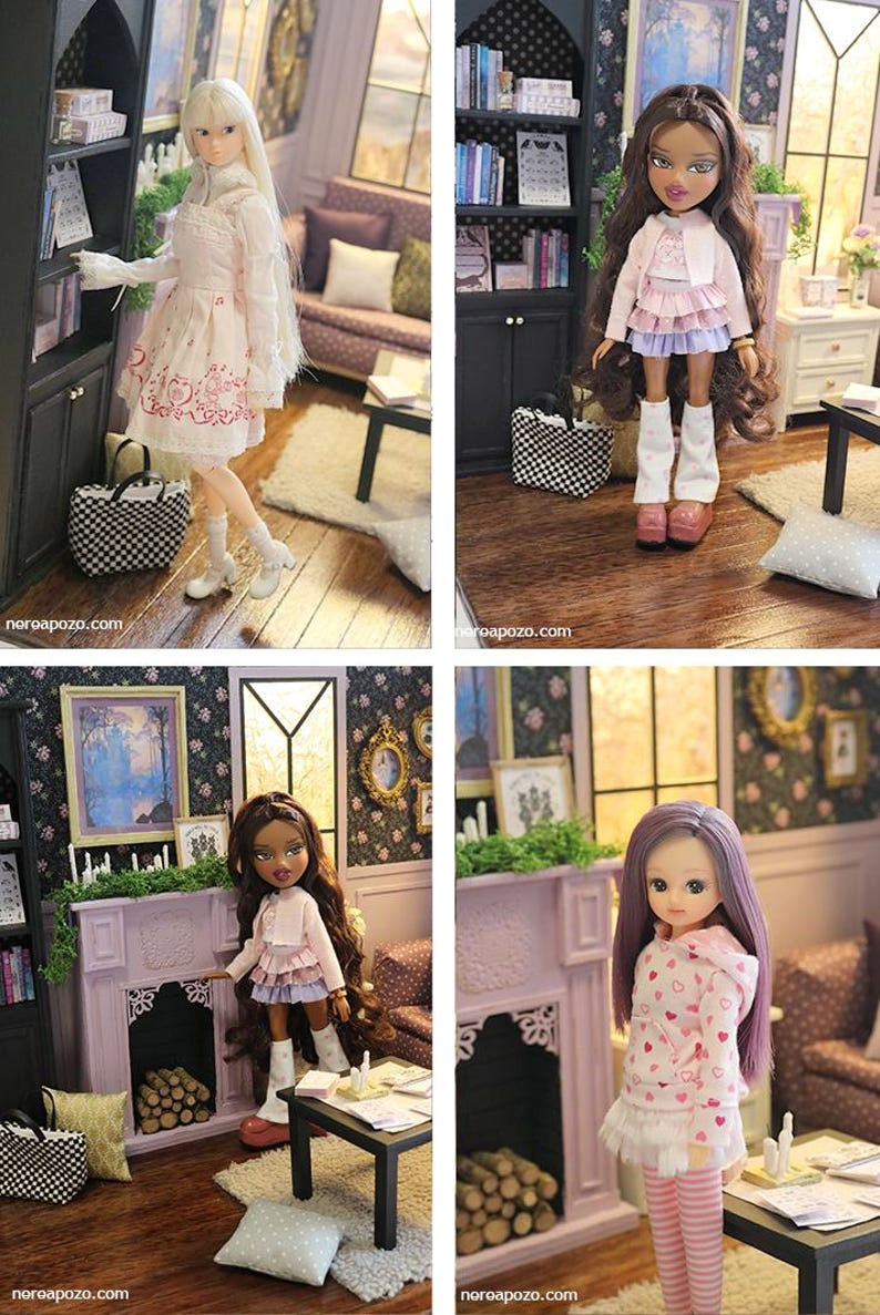 May include: A collection of four dolls in a miniature living room setting. The dolls feature varied hair colors and outfits, including dresses, skirts, and hoodies. They are positioned near a fireplace, a bookshelf, and a small table.
