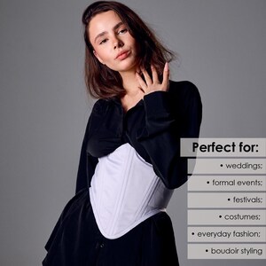 May include: A white corset with vertical seam detailing. The corset is worn over a black top. The image includes text that says "Perfect for: weddings; formal events; festivals; costumes; everyday fashion; boudoir styling."