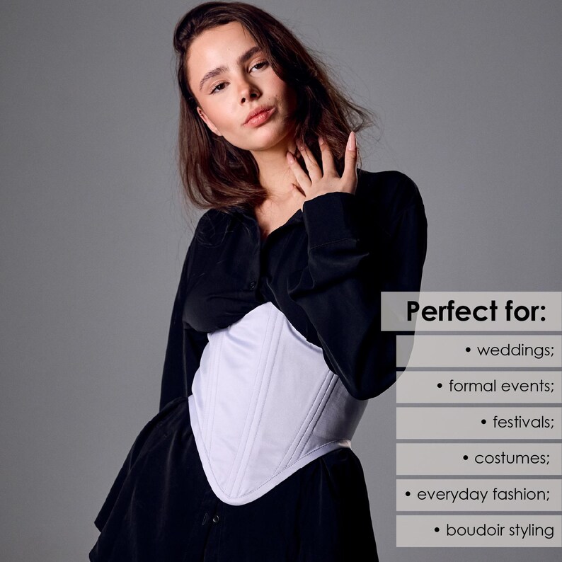 May include: A white corset with vertical seam detailing. The corset is worn over a black top. The image includes text that says "Perfect for: weddings; formal events; festivals; costumes; everyday fashion; boudoir styling."