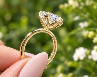 May include: A gold ring featuring a large, clear, faceted gemstone held in a six-prong setting. The band is smooth and polished yellow gold, with the engraving 14K visible on the inner surface of the ring shank, showcasing a classic design.