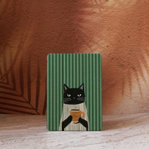 May include: A rectangular case featuring a black cat illustration holding a yellow and orange mug. The background has green vertical stripes. The cat wears a white and black striped apron.