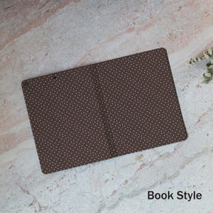 May include: A brown, book-style cover with a white polka dot pattern. The cover is rectangular and open, displaying the interior. The text "Book Style" is visible at the bottom.
