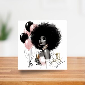 May include: A birthday greeting card featuring an illustration of a woman with a large afro, holding a champagne glass. Black and pink balloons are in the background. The words "Happy Birthday" are written in elegant script.