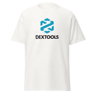 May include: White t-shirt with a blue geometric logo and the text "DEXTOOLS" in black. The logo is a stylized hexagon with intersecting arrows. The shirt has short sleeves and a crew neck.