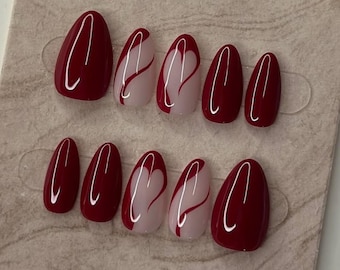 May include: A set of ten oval-shaped, press-on nails. The nails alternate between solid burgundy and a design featuring a white heart with burgundy accents. The nails are displayed on a beige card with the text "Thank you for your order. I hope you like it."