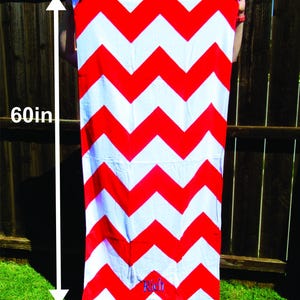 Puede incluir: Una toalla de playa con estampado de chevr&oacute;n rojo y blanco. La toalla mide 152 cm de largo y 76 cm de ancho. La palabra "Rich" est&aacute; bordada en la parte inferior de la toalla. Las palabras "Towel Size" est&aacute;n en la parte superior.