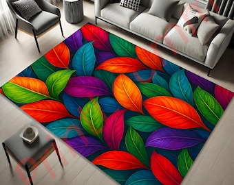 May include: A rectangular area rug featuring a vibrant pattern of large, stylized leaves in shades of red, orange, green, blue, and purple. The rug has a dark blue background and is placed on a light-colored wooden floor.