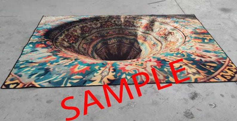 May include: A colorful rug with a large, circular hole in the center, creating an optical illusion of a swirling vortex. The rug has a black border and intricate patterns in shades of blue, green, red, and yellow.