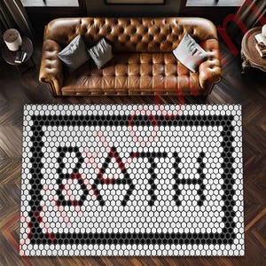 May include: A black and white geometric patterned rug with a honeycomb design. The rug features the word "BATH" in a bold, stylized font. The rug is rectangular and has a black border.