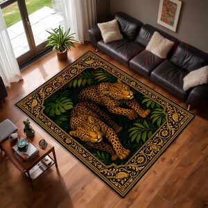 May include: A rectangular area rug featuring two leopards resting amidst dark green tropical foliage. The rug is framed by an ornate gold and black border with floral motifs and small bird illustrations, set against a dark background.
