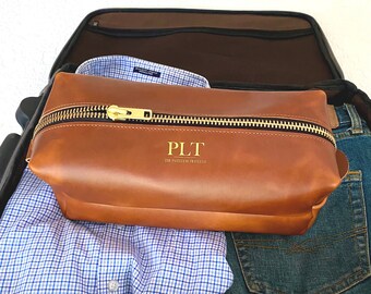 Full Grain Leather Toiletry Travel Bag. Choose from brown or black leather and nickel or brass finishes. Large end-to-end zipper. 11"x5"x5"