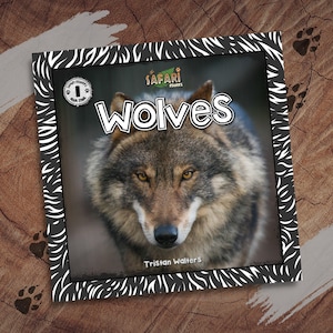 May include: A children's book titled "Wolves" featuring a close-up image of a wolf's face. The book has a black and white zebra-striped border and the author's name, Tristan Walters, is visible.