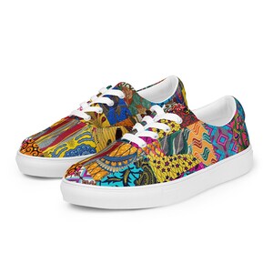 May include: A pair of low-top sneakers featuring a vibrant, multi-colored patchwork pattern with various geometric and floral motifs in shades of yellow, blue, red, and pink. The shoes have white laces and a solid white rubber sole.