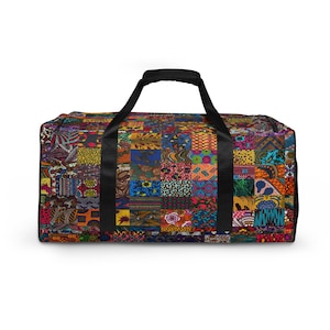 May include: A rectangular duffel bag featuring a vibrant patchwork design composed of various colourful geometric and floral patterns. The bag includes two black fabric handles attached to the top, with a black zip closure along the upper edge.