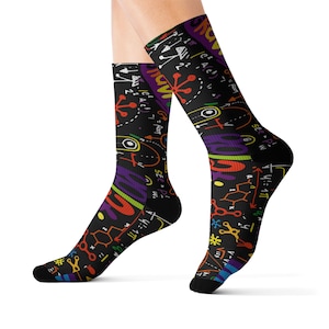 May include: A pair of black crew socks featuring a vibrant, multicolored pattern of scientific and mathematical symbols, including chemical structures, geometric shapes, and the text "Root" and "See Pi" printed in bold, bright colors.