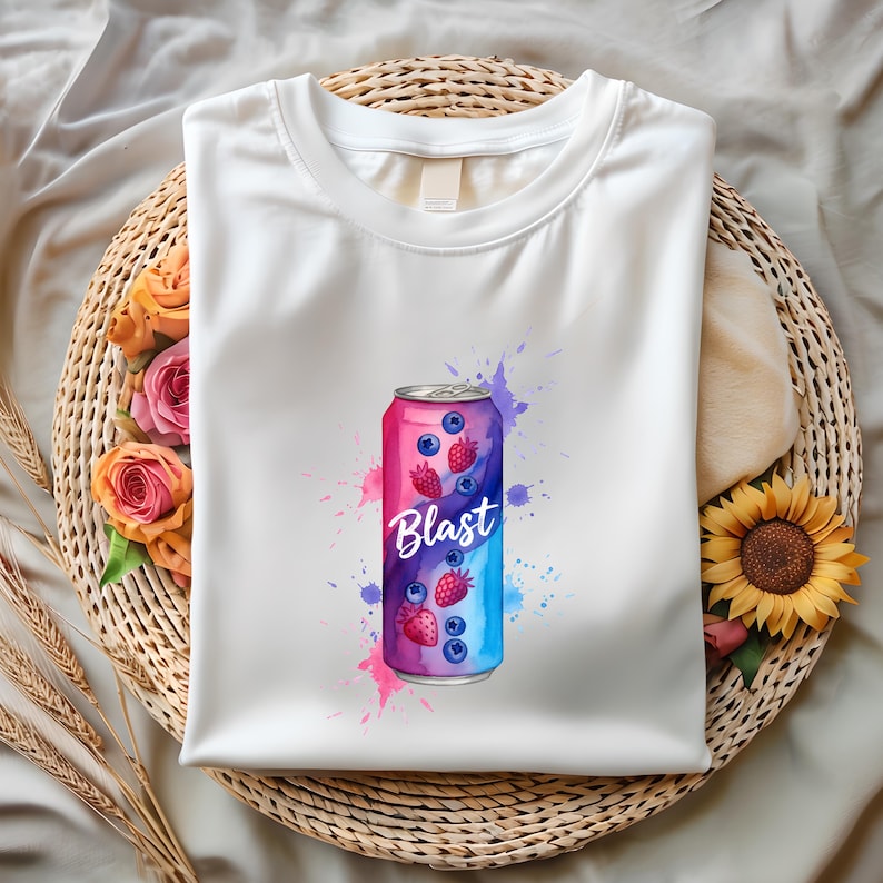 May include: White t-shirt with a vibrant graphic of a drink can. The design features the word "Blast" and illustrations of blueberries and strawberries, set against pink and blue watercolour splashes.