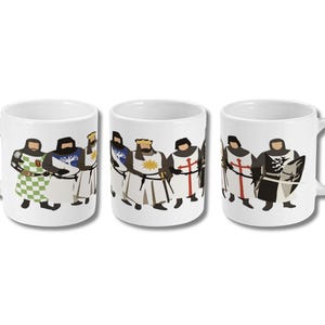 May include: Three white ceramic mugs with a wraparound design featuring cartoon knights in various outfits. The knights are depicted in a flat, illustrative style, with bold colors and simple shapes. The mugs have a standard handle.