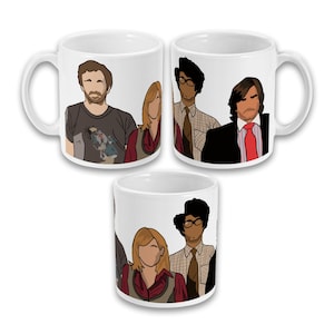May include: Three white ceramic mugs with a cartoon illustration of a group of people. The mugs show the characters with black outlines and various clothing styles. The mugs are arranged in a triangular pattern.