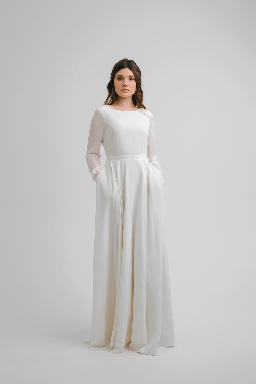 A-Line Crepe Wedding Dress: Long Sleeve Bridal Gown with Pockets A-Line Crepe Wedding Dress: Long Sleeve Bridal Gown with Pockets