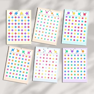 May include: Six rectangular sticker sheets featuring grids of colorful shapes. The sheets display rows of crosses, four-pointed stars, squares, circles, five-pointed stars, and eight-pointed stars in various bright colors including pink, blue, yellow, and green.