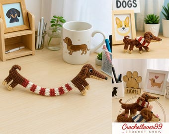 May include: A collection of dachshund-themed items, including a crochet dog with a red and white striped body, a mug with a dachshund illustration, and framed dog portraits. The crochet dog has brown and tan details.