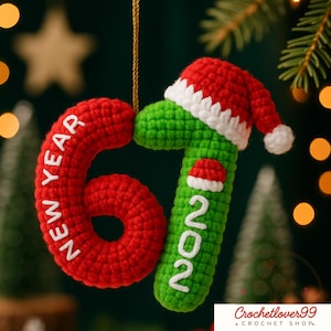May include: Crocheted Christmas ornament featuring the numbers "6" and "1" in red and green, respectively, with "NEW YEAR" and "2021" in white. The "1" is adorned with a miniature Santa hat. A festive holiday decoration.