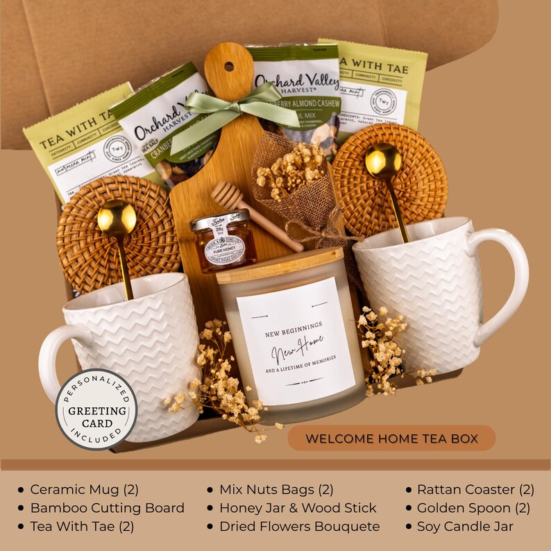 Peut inclure: Un coffret cadeau de bienvenue avec deux tasses en c&eacute;ramique blanches, du th&eacute;, une planche &agrave; d&eacute;couper en bambou et une bougie de soja. Le coffret contient &eacute;galement du miel, des noix et des fleurs s&eacute;ch&eacute;es. La bougie porte l'inscription "New Beginnings".