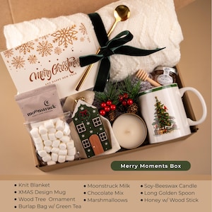 Green Christmas gift box with tartan mug, honey jar, marshmallows, blanket, and candle — cozy holiday self care box for women or festive home gift idea.
