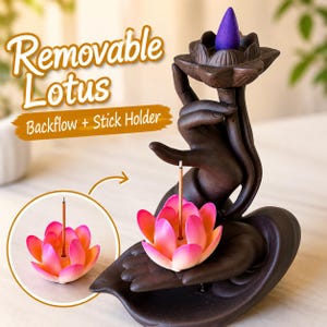 May include: A dark brown ceramic incense burner shaped like a hand holding a lotus flower. It features a removable pink and orange lotus incense stick holder and a purple cone incense on top. Text reads Removable Lotus Backflow + Stick Holder.