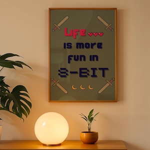 May include: A framed print with a green background and the text "Life is more fun in 8-BIT" in a pixelated font. The text is surrounded by pixelated swords and hearts.