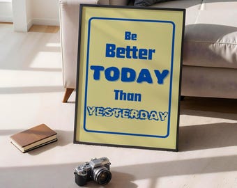 May include: A motivational poster with a yellow background and black frame. The text on the poster reads "Be Better TODAY Than YESTERDAY" in blue letters.