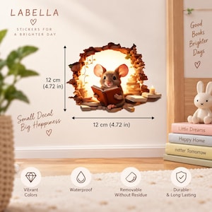 May include: A wall decal featuring a brown mouse reading a book inside a glowing hole in a wall, surrounded by stacked books and a candle. The decal measures 12 cm by 12 cm. Text includes LABELLA, Small Decal Big Happiness, and Good Books Brighter Days.