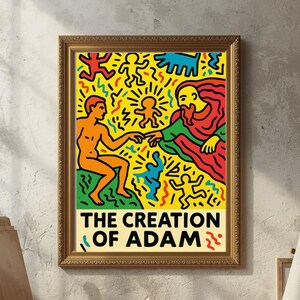 以下が含まれることがあります： キース・ヘリングの「アダムの創造」の額装されたプリント。黄色、赤、青の鮮やかな人物が描かれています。アートワークは、画材、イーゼル、木の床がある部屋にあり、芸術的な雰囲気を作り出しています。