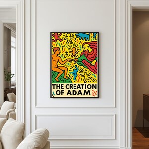 以下が含まれることがあります： 鮮やかな色彩で描かれた「アダムの創造」の額装アートプリント。黄色い背景に、大胆な色使いで描かれた様式化された人物像が特徴で、下部には「THE CREATION OF ADAM」のタイトルが記されています。
