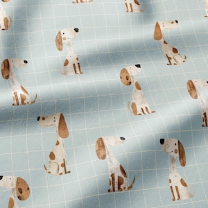 May include: A light blue fabric featuring a repeating grid pattern of thin white lines and illustrations of brown and white spotted dogs in various sitting positions. The dogs have long ears, simple facial features, and brown patches on their bodies.