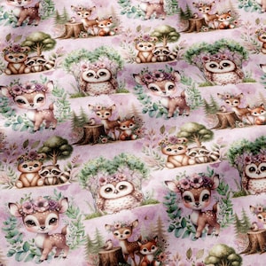 May include: A fabric pattern featuring repeating illustrations of cartoon deer, owls, and raccoons adorned with floral crowns. The animals are set against a light purple background with green trees and foliage, creating a whimsical woodland scene.