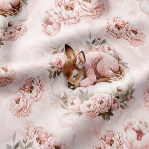 May include: A fabric print featuring a sleeping fawn wearing a light pink polka dot onesie, nestled among large, soft-petaled pink peony flowers and green leaves on a pale pink background. The pattern repeats the floral and fawn motif throughout.