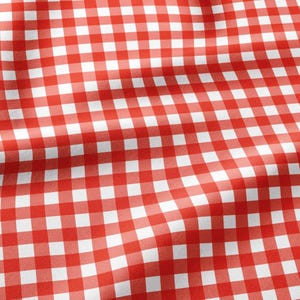 May include: A fabric featuring a classic red and white gingham check pattern. The material displays soft folds and ripples across the surface, highlighting the consistent square grid design of the textile with its vibrant red and white colors.