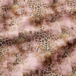 May include: A fabric featuring a repeating leopard print pattern in shades of brown and black, layered over a soft, muted pink background with a distressed, textured effect that creates a weathered appearance across the entire surface.