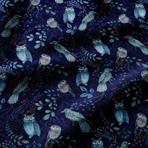 May include: A dark navy blue fabric featuring a repeating pattern of light blue and teal owls interspersed with intricate botanical illustrations of leaves, branches, and small red berries. The design covers the entire surface of the textile.