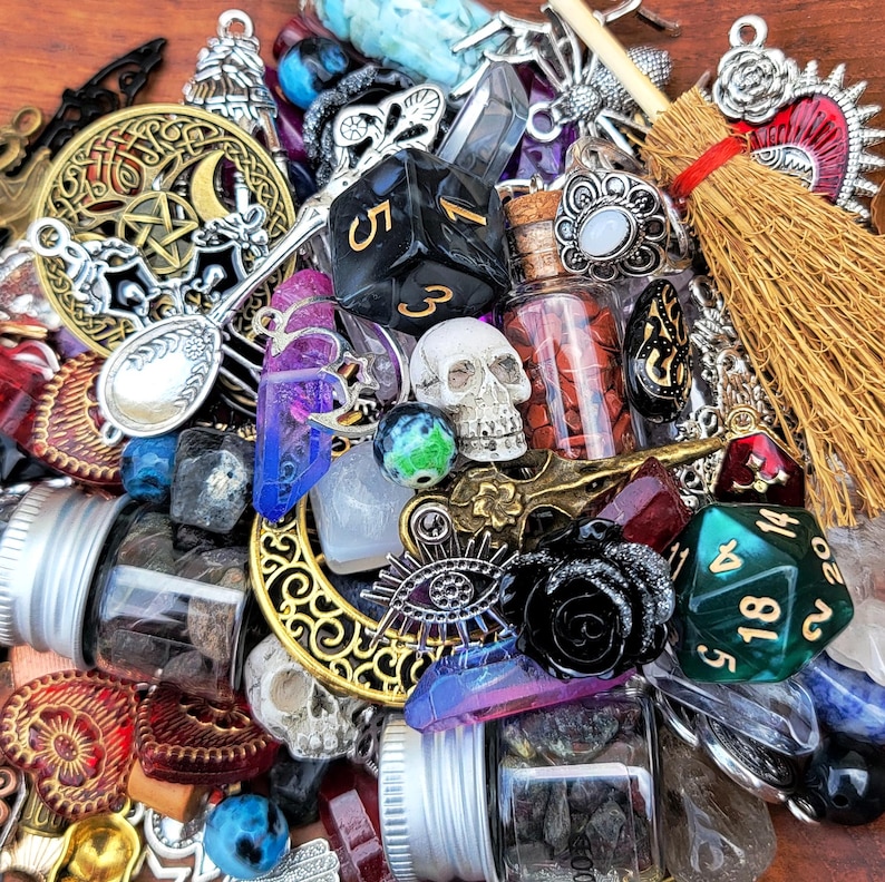 May include: A collection of assorted witchy and magical items, including a skull, dice, a bottle of herbs, a broom, and various crystals and charms.