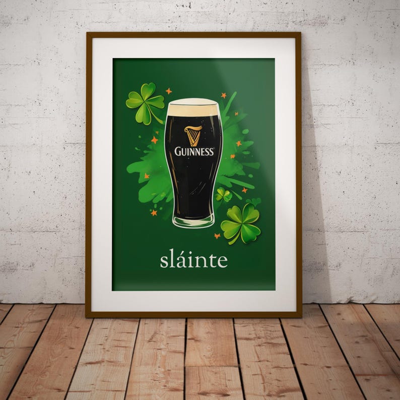 May include: A framed print with a green background featuring a glass of Guinness beer with a shamrock design and the word "sl&aacute;inte" in white text.
