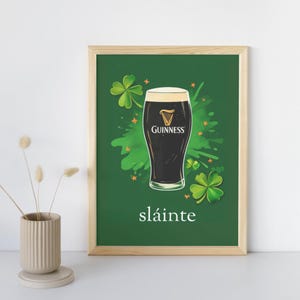 May include: A green poster featuring a glass of Guinness beer, shamrocks, and the word "sl&aacute;inte" in white text.