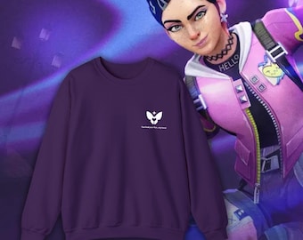 May include: A dark purple sweatshirt with a white graphic and text. The graphic is a stylized design, and the text reads "You heal your hurts, my love!" The sweatshirt is a crew neck style.