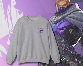 May include: Gray sweatshirt with a purple logo featuring a heart inside a circle with four points. The logo says "Killjoy's Time"