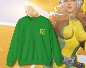 May include: A green sweatshirt with a small yellow emblem and the text "I'll take something." The sweatshirt is displayed in front of a yellow and green illustration of a character.