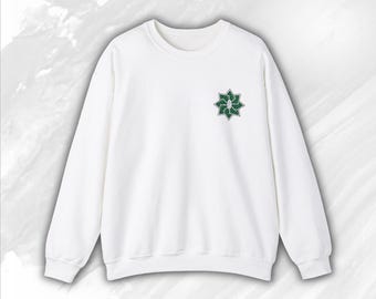 May include: White sweatshirt with a green star-shaped design on the front.