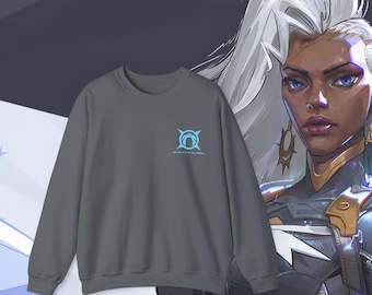 May include: A dark gray sweatshirt with a blue and white graphic of a symbol with the text "We are the voices of the cosmos".