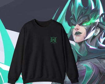 May include: Black sweatshirt with a green and white logo on the front. The logo is a stylized symbol with a circle and four lines extending from it. The sweatshirt is shown against a background of a green and black illustration of a woman with a crown of thorns.